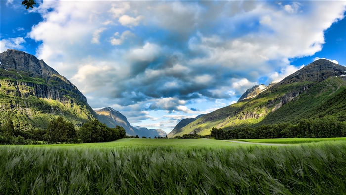 Green Field and Mountains Under Cloudy Sky 4K