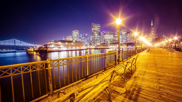 San Francisco cityscape at night with Bay Bridge and Pier 7