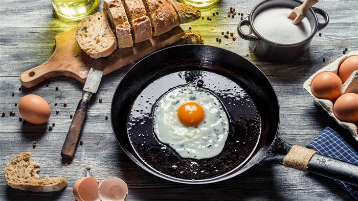 Fried egg in a pan with bread and eggs