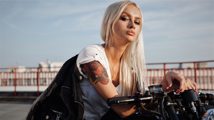 Blonde woman with tattoo on motorcycle 4K