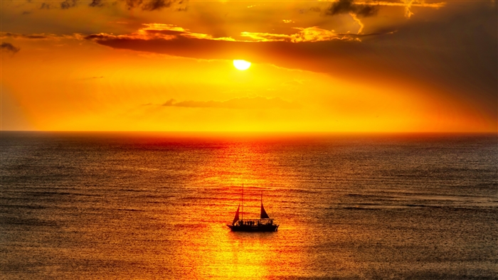 Sailboat on the ocean during a vibrant sunset
