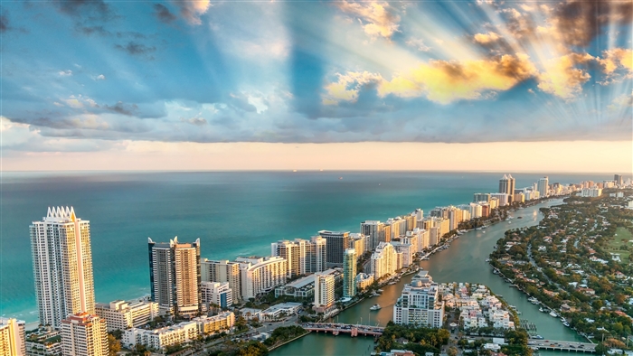 Miami cityscape with ocean and sunbeams 4K
