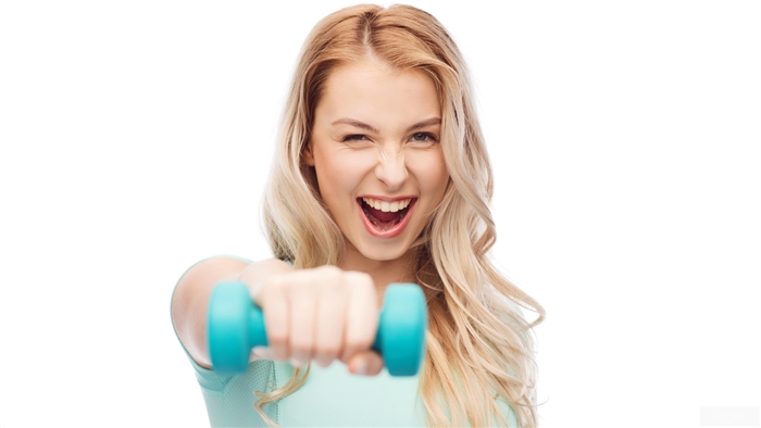 Woman lifting dumbbell and smiling 4K