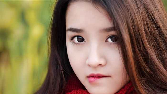 Close-up of a young woman biting her lip