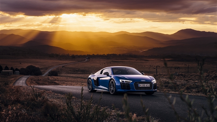 Blue Audi R8 V10 on a country road at sunset