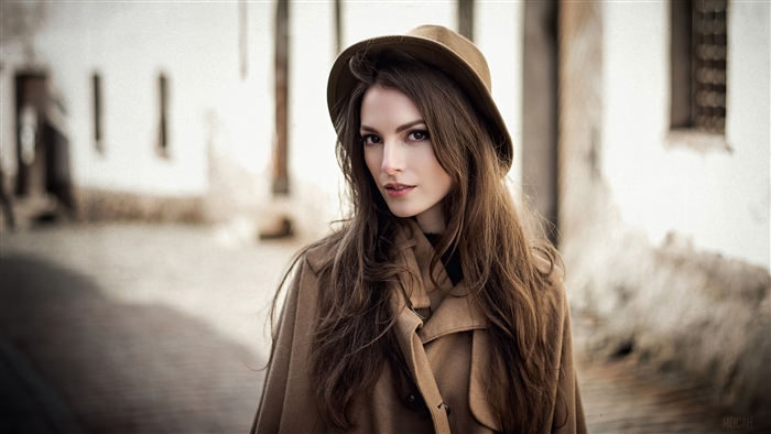 Model Karina Sunceva wearing a hat and coat
