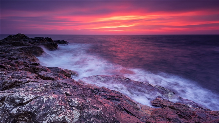 Ocean sunset with rocky shore 4K