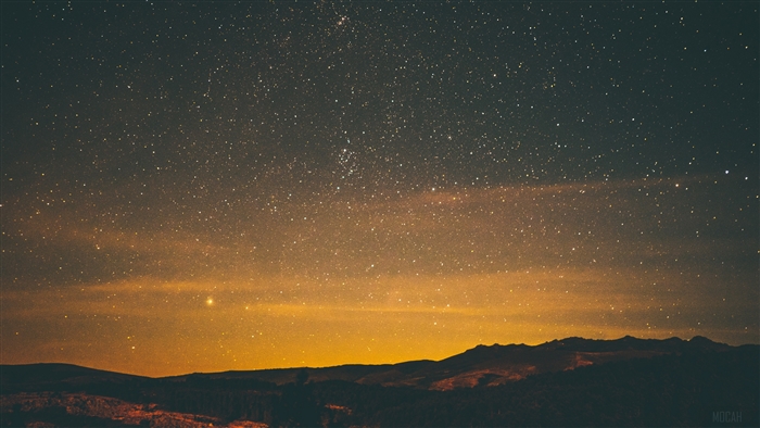 Starry night sky over mountains