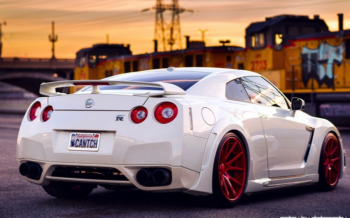 White Nissan GT-R with Red Wheels at Sunset