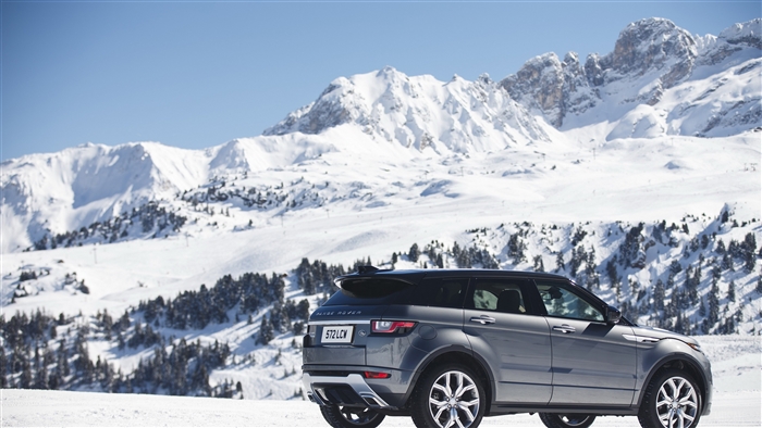 Silver Range Rover Evoque SUV in Snowy Mountains