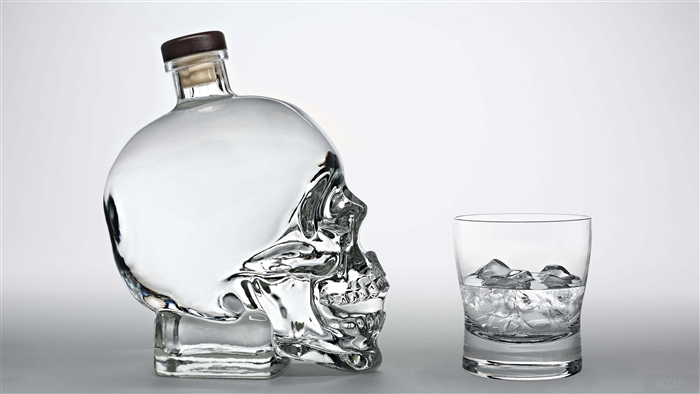 Crystal Head Vodka bottle and glass with ice