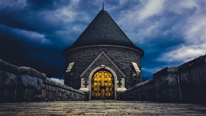 Stone Tower with Golden Doors Under Dark Sky 4K