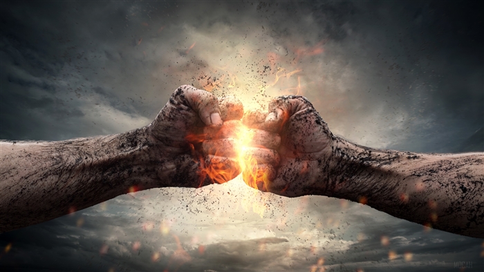 Two fists colliding with fire and dust