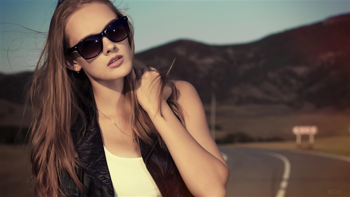 Woman in sunglasses on a road