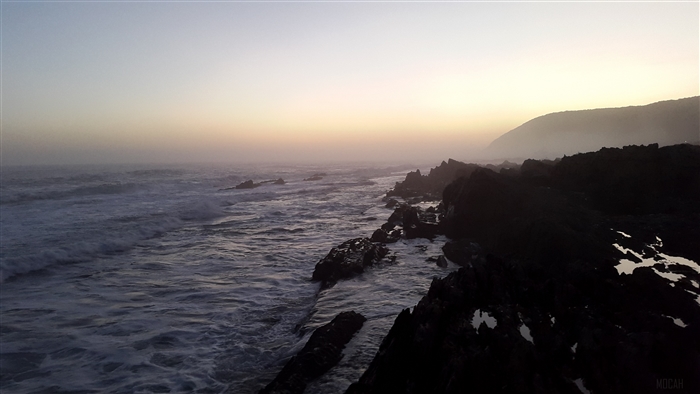 Ocean waves crashing on rocky coastline at sunset, South Africa 4K