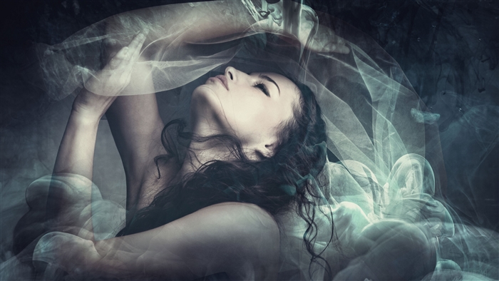 Woman in sheer fabric and smoke