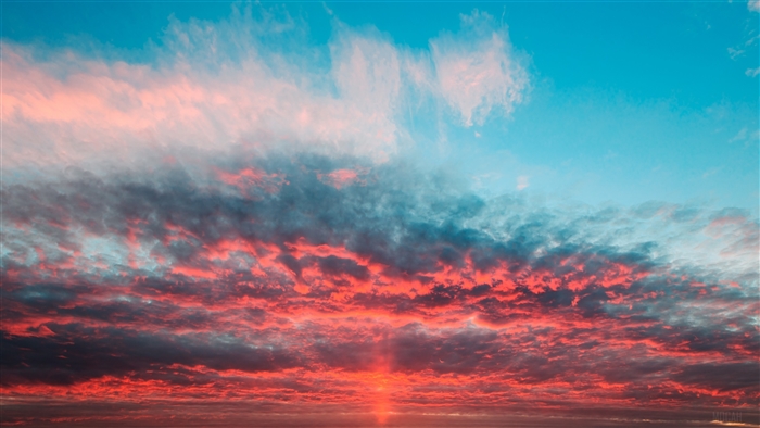 Sunrise over the ocean with colorful clouds