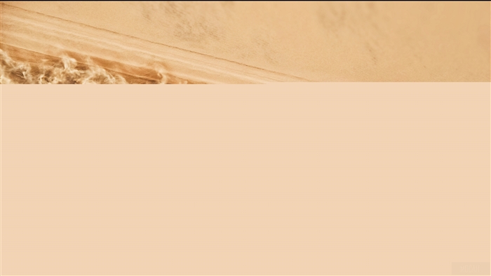 Car driving through sand dunes