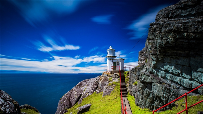Ireland Lighthouse by Ocean with Blue Sky 4K