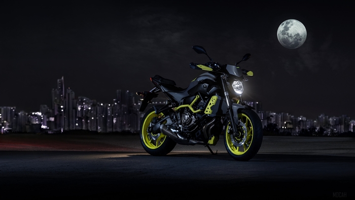 Yamaha MT-07 motorcycle at night with city skyline and moon