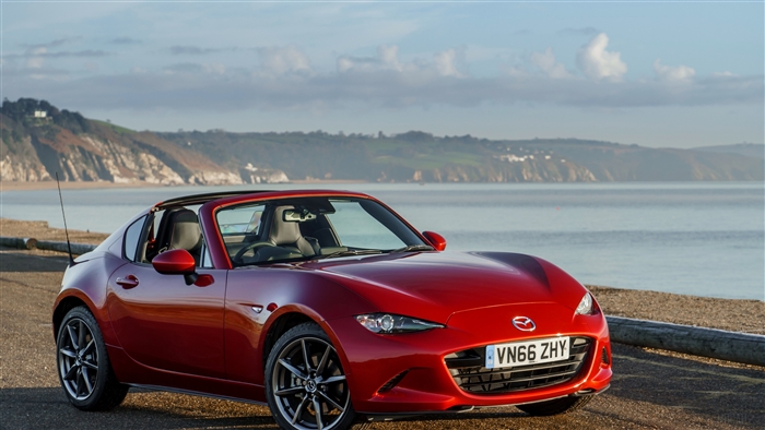 Red Mazda MX-5 RF parked by the sea