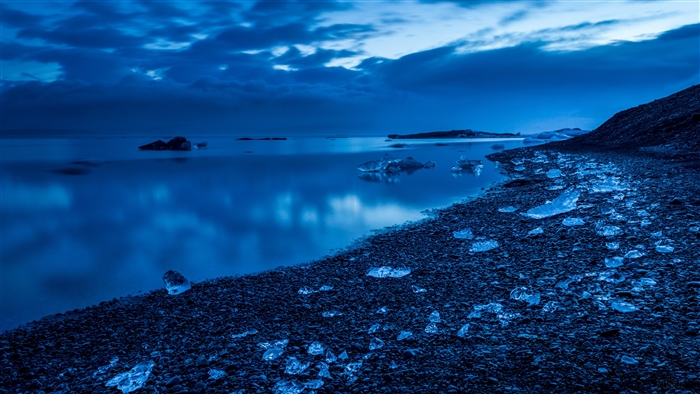 Serene Night Coastline with Ice in Blue Hue