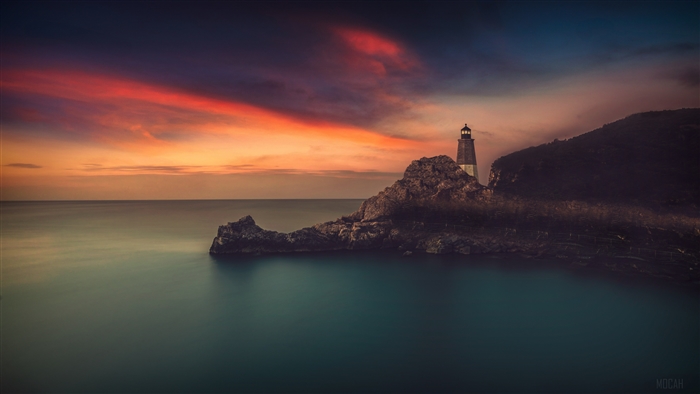 Lighthouse on Rocky Coast at Sunset