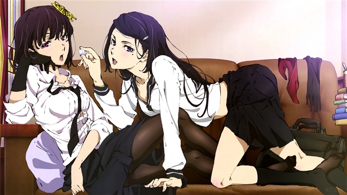 Two girls in school uniforms on a couch