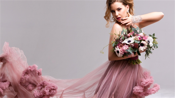 Woman in Pink Dress Holding Bouquet