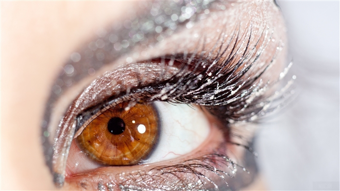 Close-up of a brown eye with glitter makeup