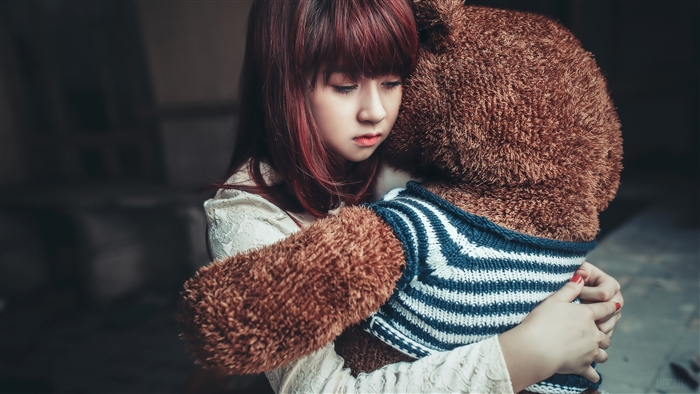 Girl hugging a teddy bear