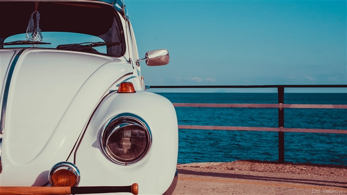 White Volkswagen Beetle by the Sea