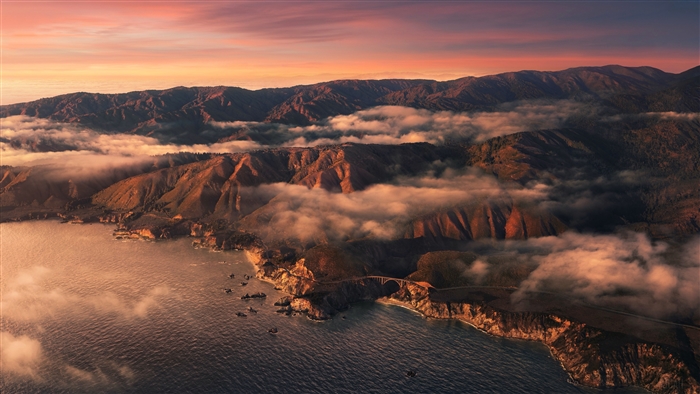 Aerial view of Big Sur coastline with mountains and clouds 4K