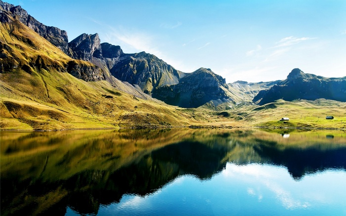 Mountain lake reflection with small houses