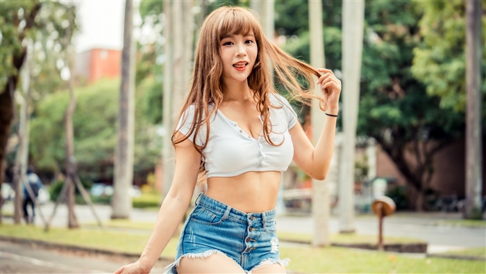 Woman in crop top and denim shorts