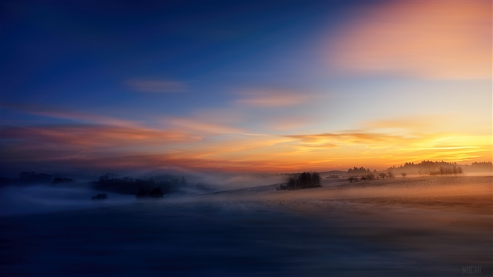 Foggy Landscape at Sunrise with Colorful Sky