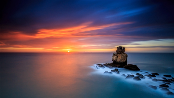 Sunset over the ocean with rock formations