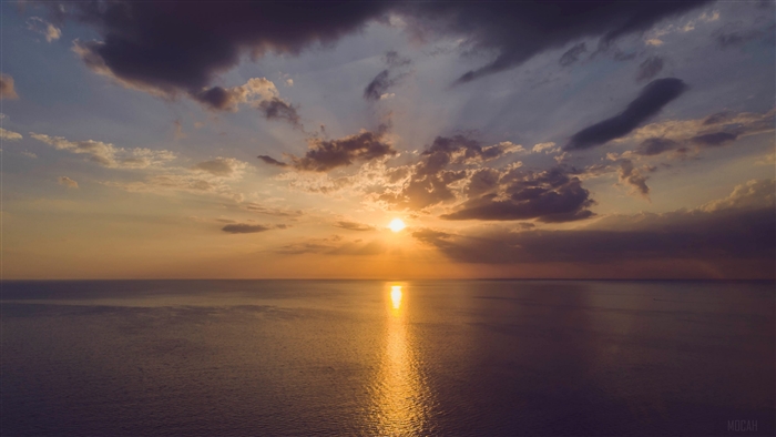 Sunset over the ocean with clouds 4K