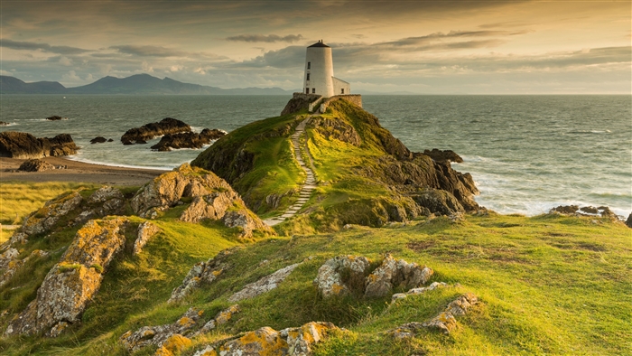 Lighthouse on a rocky hill overlooking the ocean