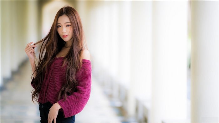 Asian woman with long brown hair wearing a maroon sweater
