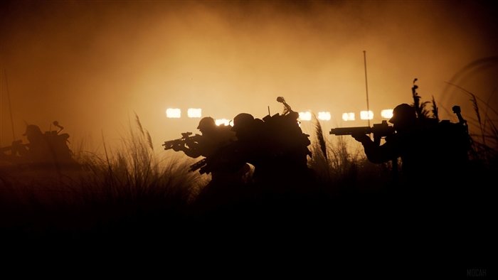 Soldiers in a foggy field with stadium lights