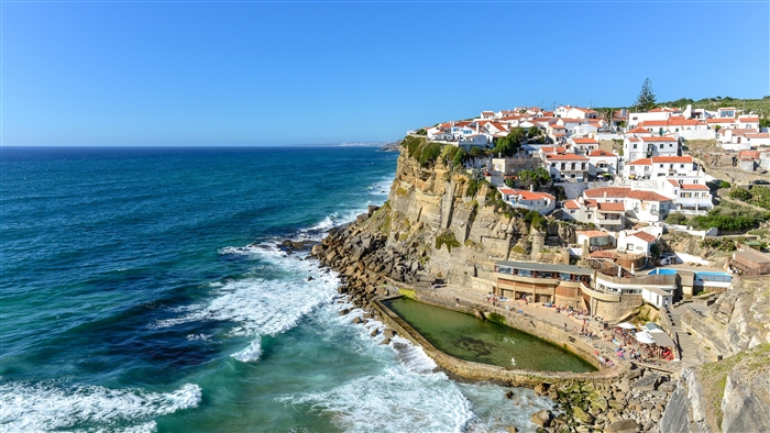 Coastal town with buildings on cliffs overlooking the ocean