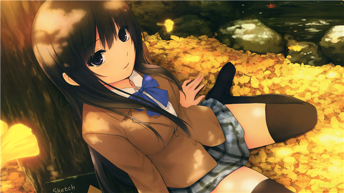 Girl in school uniform lying in autumn leaves