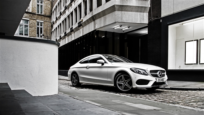 White Mercedes-Benz C-Class Coupe on Cobblestone Street