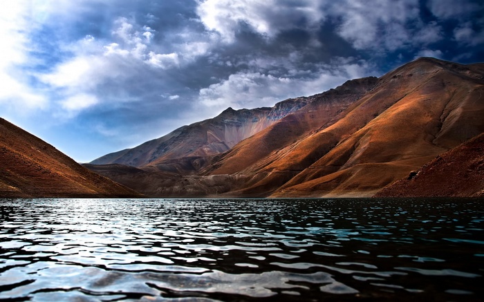 Lake and Mountains Under Cloudy Sky