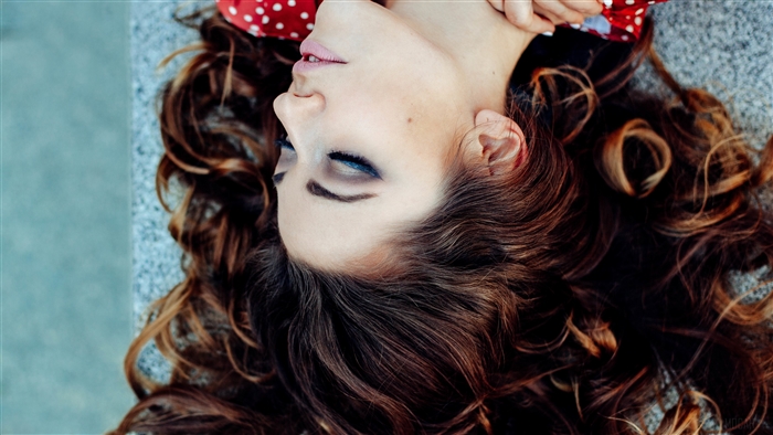 Brunette Woman Lying Down with Red Polka Dot Headband 4K