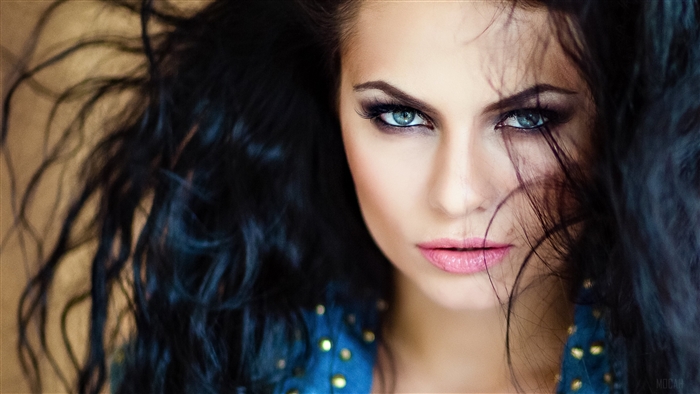 Brunette woman with blue eyes close-up 4K
