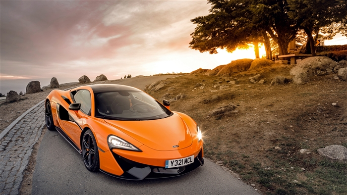 Orange McLaren 570S Supercar on a Road at Sunset 4K