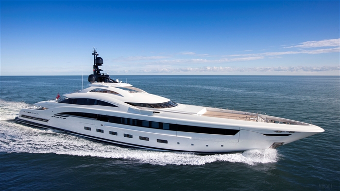 A large white yacht sails on the ocean