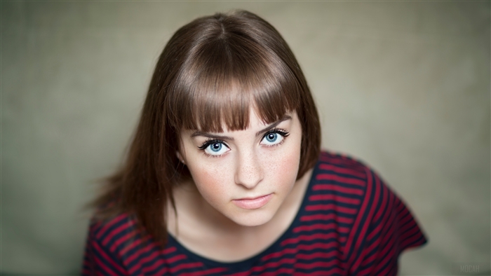 Portrait of a Brunette Woman with Blue Eyes and Freckles